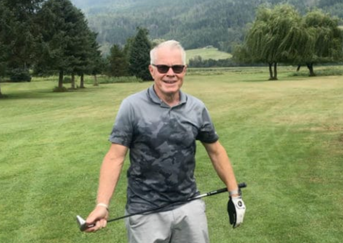 A golfer smiling while on the course